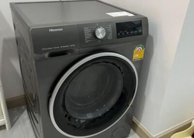 A washing machine in a laundry room