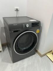 A washing machine in a laundry room