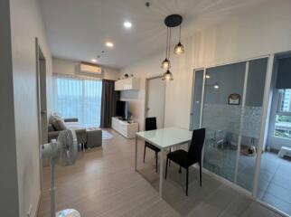 Modern living room with dining area and large window