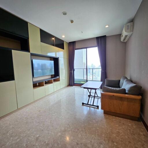 Modern living room with a large window and built-in entertainment unit