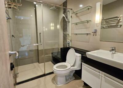 Modern bathroom with glass shower and white fixtures