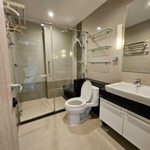 Modern bathroom with glass shower and white fixtures