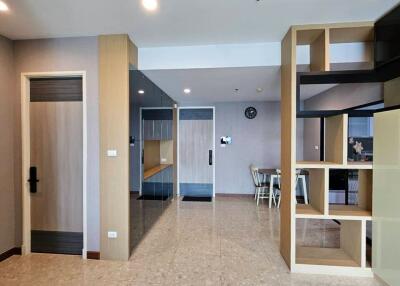 Modern living area with tiled flooring and built-in shelving