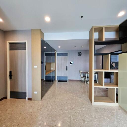 Modern living area with tiled flooring and built-in shelving