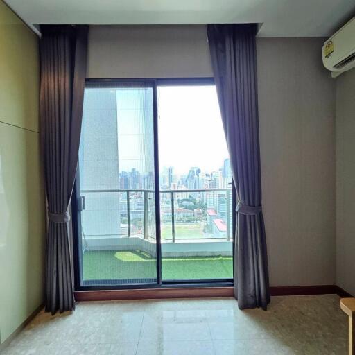 Living room with large window and balcony view