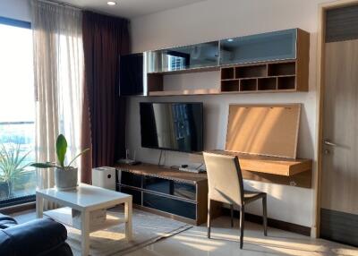 Modern living room with entertainment unit and natural light