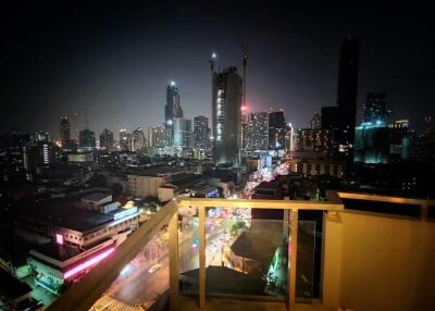 Night view of city skyscrapers from high-rise balcony