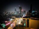 Night view of city skyscrapers from high-rise balcony