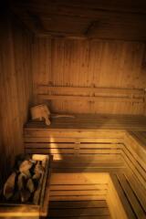 Wooden sauna interior with bench and sauna stones