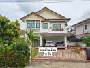 Two-story house with front garden and garage