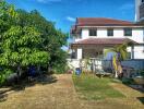 Backyard view of a house with garden and trees