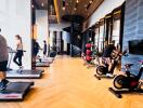 Modern gym with various exercise equipment and a spiral staircase