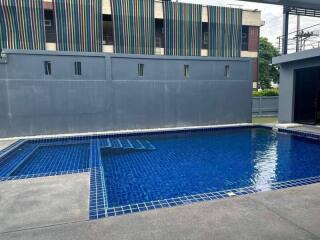 Private swimming pool in an outdoor area with surrounding pavement