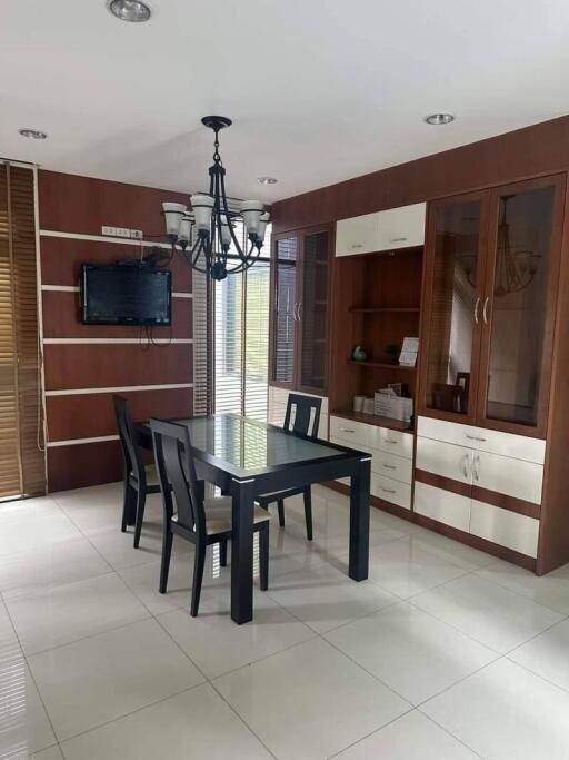 Dining room with wooden cabinets and a chandelier