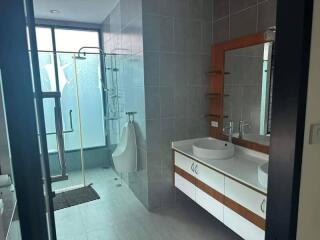 Modern bathroom with shower area and urinal