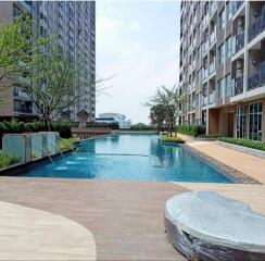 Outdoor communal swimming pool between modern apartment buildings