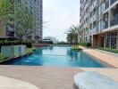 Outdoor communal swimming pool between modern apartment buildings