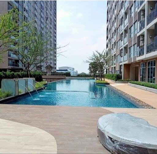 Outdoor communal swimming pool between modern apartment buildings