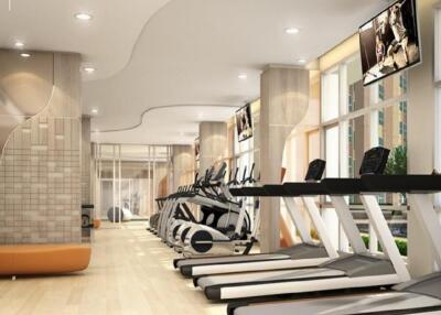 Modern gym with various exercise equipment including treadmills and elliptical machines