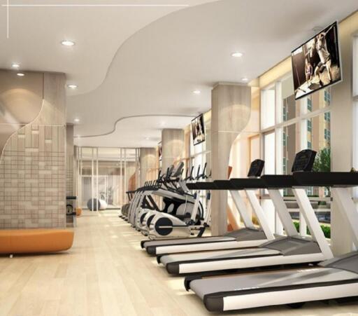 Modern gym with various exercise equipment including treadmills and elliptical machines