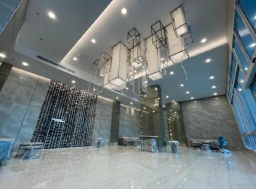 Spacious modern lobby with luxurious lighting and marble flooring