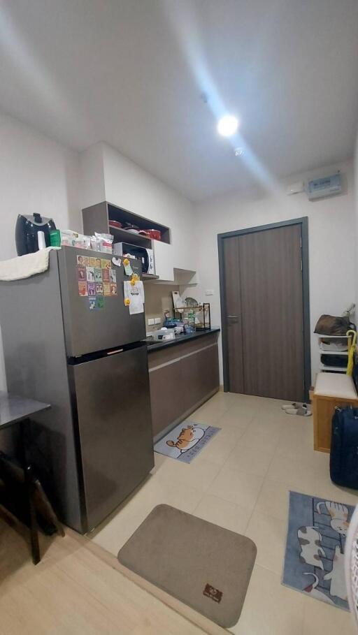 Compact modern kitchen with appliances and a fridge