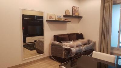 Modern living room with a mirrored wall and a TV unit