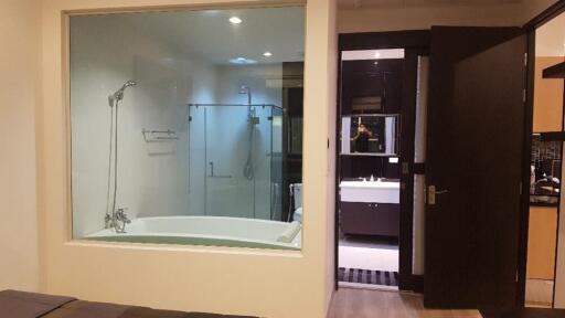 Modern bathroom with bathtub and glass-enclosed shower