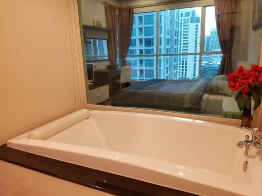 Modern bathroom with a view of a bedroom