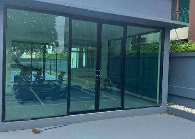 Building with glass doors and outdoor sports court