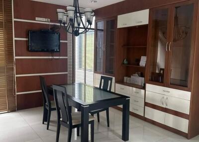 Modern dining room with wooden cabinets and chandelier