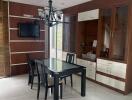 Modern dining room with wooden cabinets and chandelier