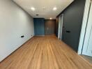 Unfurnished living space with hardwood floors and recessed lighting