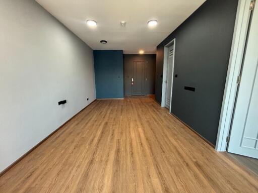 Unfurnished living space with hardwood floors and recessed lighting