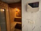 Indoor sauna with wooden interior and control panel on the wall