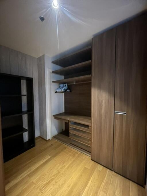 Spacious closet with wooden shelves and storage compartments