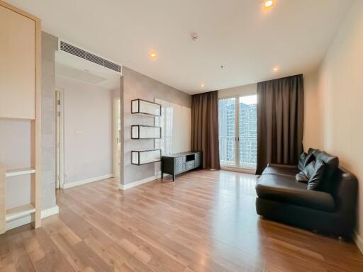 Spacious modern living room with wooden flooring and large windows