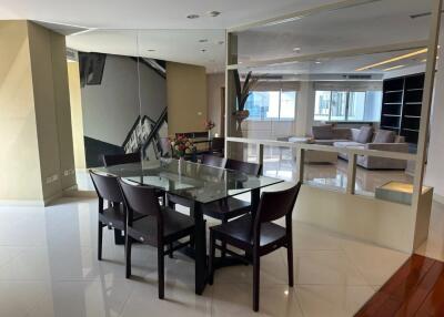 Modern dining area with glass table and six chairs