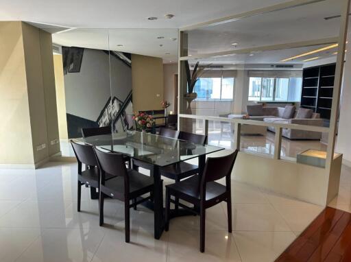 Modern dining area with glass table and six chairs