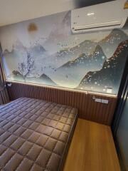 Bedroom with artistic wall mural and air conditioning