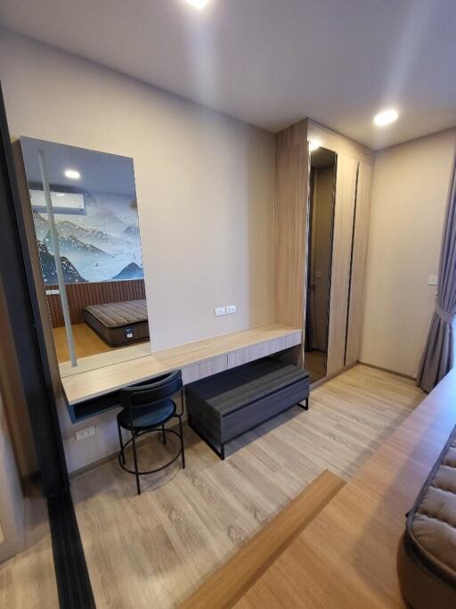 Modern bedroom with furniture and a large wall-mounted mirror