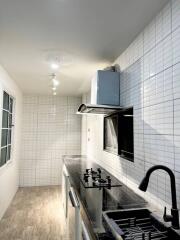 Modern kitchen with white tile backsplash and stainless steel appliances
