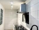 Modern kitchen with white tile backsplash and stainless steel appliances