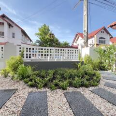 Well-maintained garden with a stone pathway and seating area