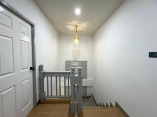Hallway with stairway and white walls