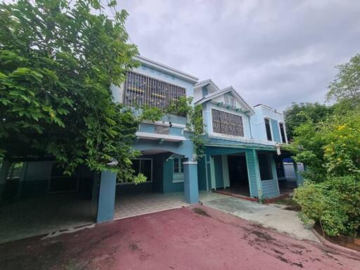 Two-story residential building with blue exterior