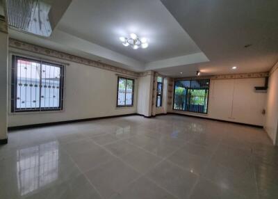 Spacious living room with tiled floor and large windows