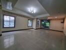 Spacious living room with tiled floor and large windows