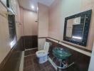 Modern bathroom with sink, toilet, and wall mirror