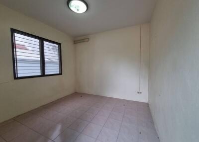 Empty bedroom with tiled floor and window